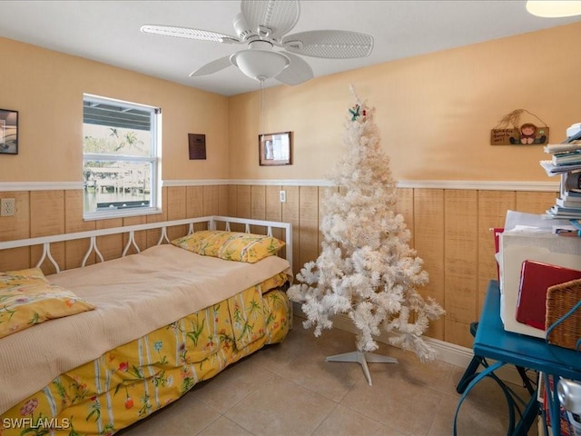 tiled bedroom featuring wooden walls and ceiling fan