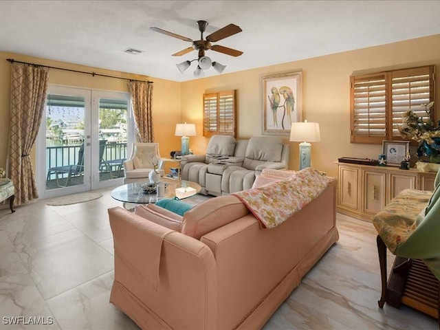living room with ceiling fan and french doors