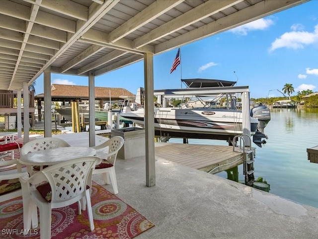 view of patio with a dock and a water view