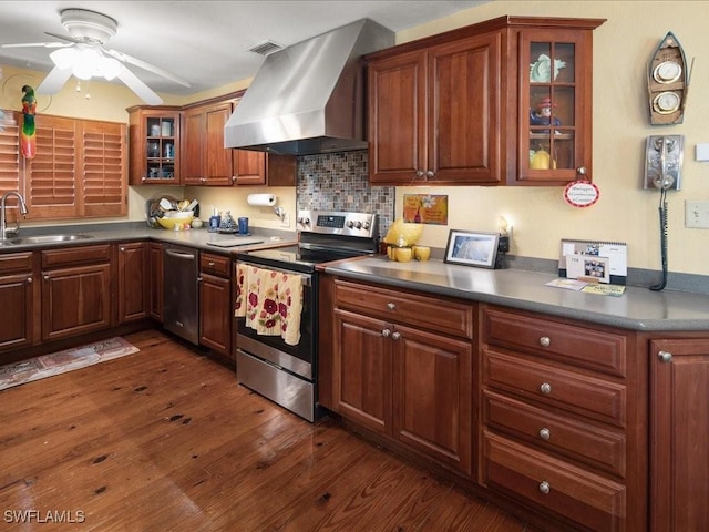 kitchen with sink, island range hood, dark hardwood / wood-style floors, ceiling fan, and stainless steel appliances