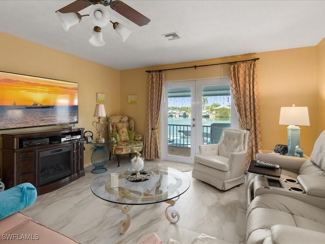 living room featuring ceiling fan and french doors