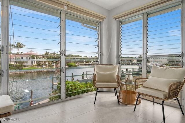 sunroom featuring a water view