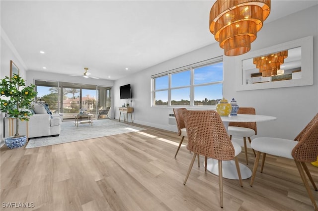 dining space with light wood-type flooring and a wealth of natural light