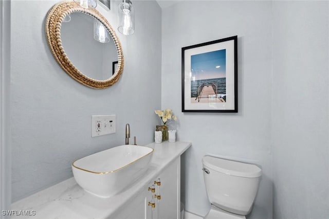 bathroom featuring toilet and vanity