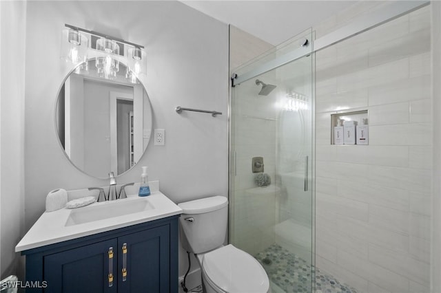 bathroom with an enclosed shower, vanity, and toilet