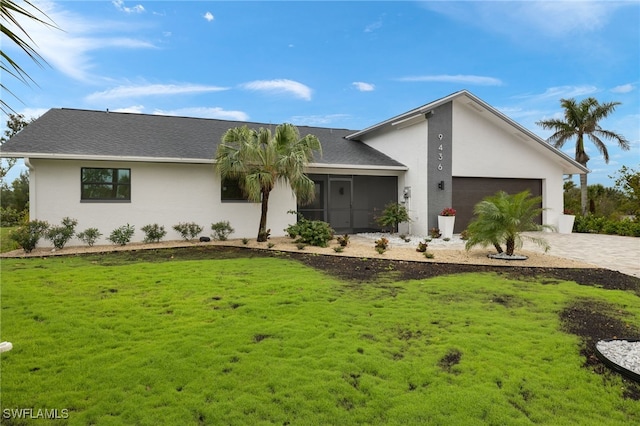 ranch-style home featuring a garage and a front lawn