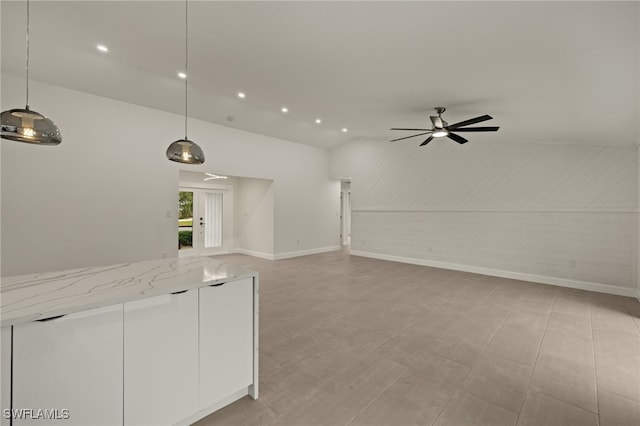 unfurnished living room featuring lofted ceiling and ceiling fan