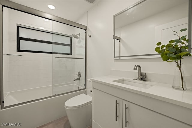 full bathroom with toilet, enclosed tub / shower combo, and vanity