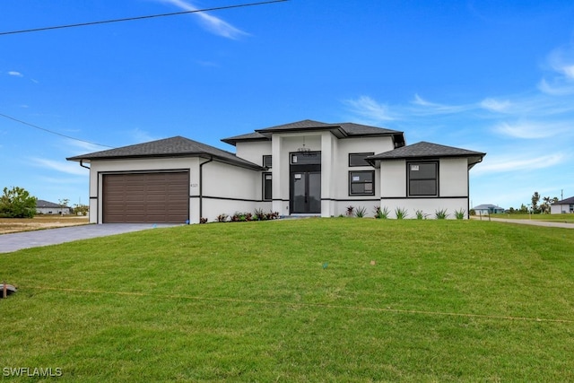 prairie-style home with a garage and a front yard