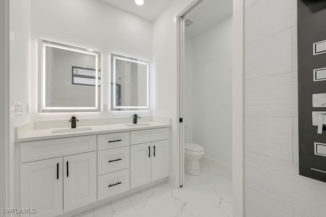 bathroom featuring toilet and vanity