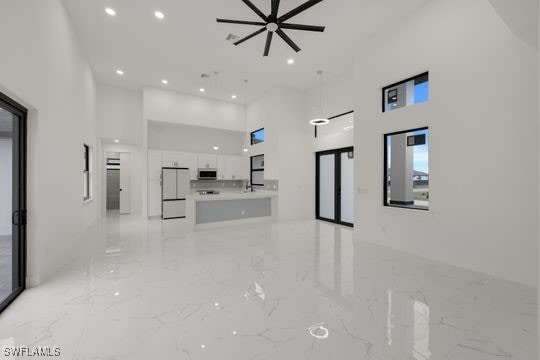 unfurnished living room with a high ceiling