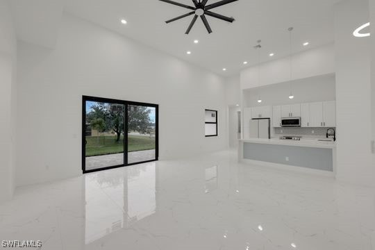 unfurnished living room with a high ceiling