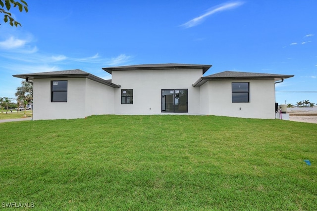 rear view of house with a yard