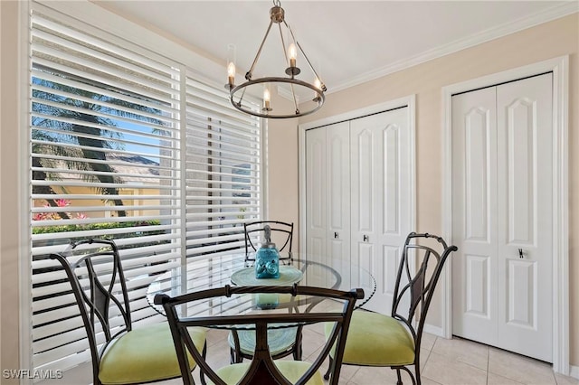 dining space with light tile patterned flooring, a chandelier, plenty of natural light, and ornamental molding