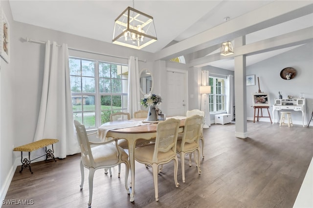 dining space featuring dark wood-type flooring, lofted ceiling, and a healthy amount of sunlight