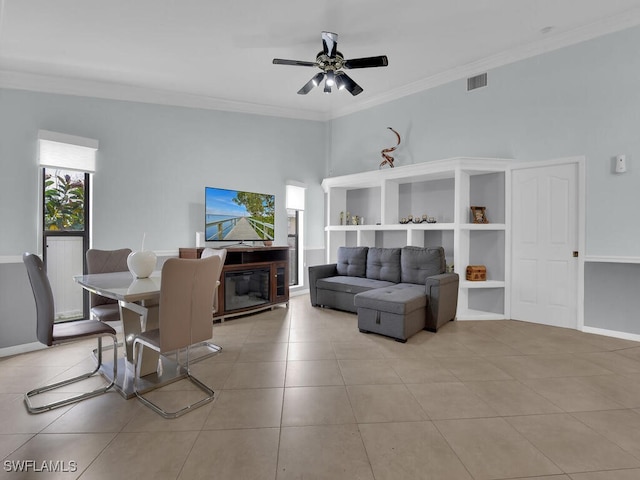 tiled living room featuring ceiling fan and ornamental molding