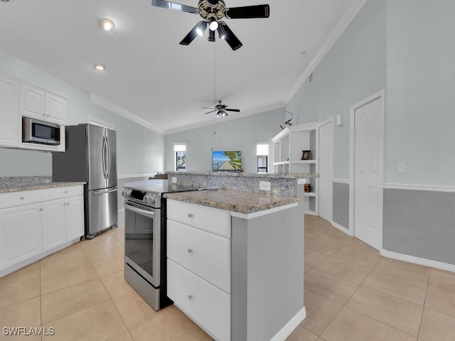 kitchen featuring lofted ceiling, a center island, white cabinetry, stainless steel appliances, and light tile patterned floors