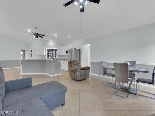 tiled living room with ceiling fan, ornamental molding, and lofted ceiling