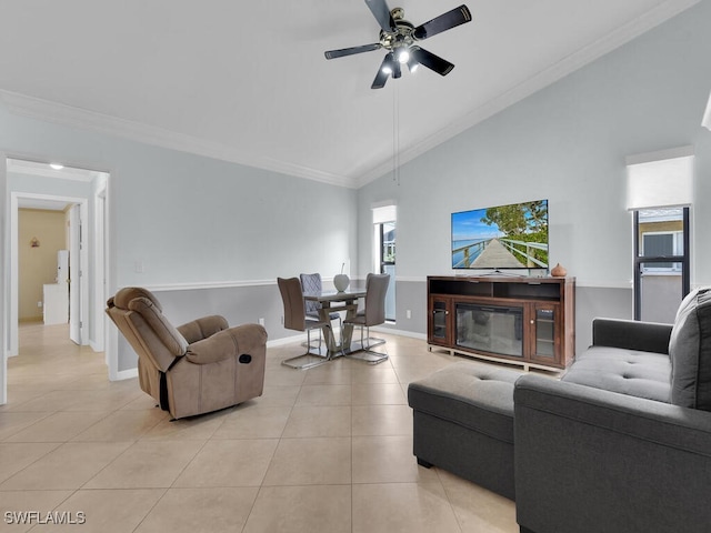 tiled living room featuring vaulted ceiling, ceiling fan, and crown molding