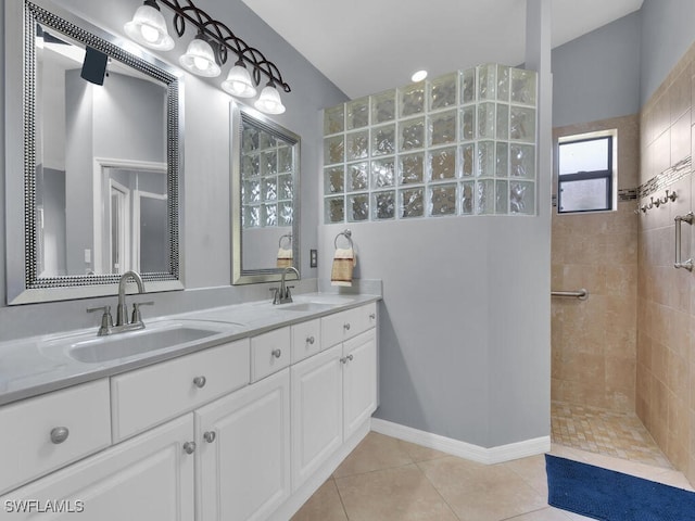 bathroom featuring vanity, tile patterned floors, and tiled shower