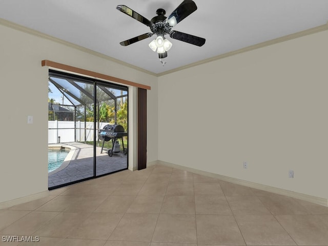 unfurnished room with ceiling fan, light tile patterned floors, and ornamental molding