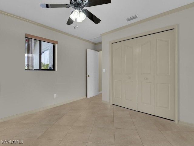 unfurnished bedroom featuring ceiling fan, a closet, ornamental molding, and light tile patterned flooring