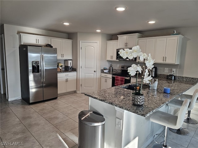 kitchen featuring electric range oven, white cabinetry, stainless steel fridge, light tile patterned floors, and kitchen peninsula