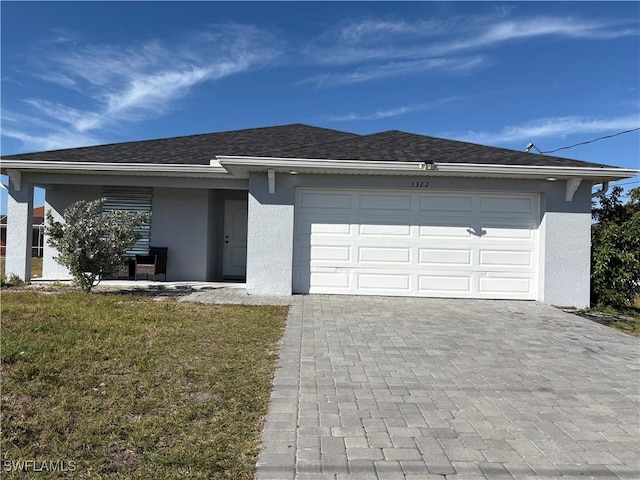 view of front of house featuring a garage and a front lawn