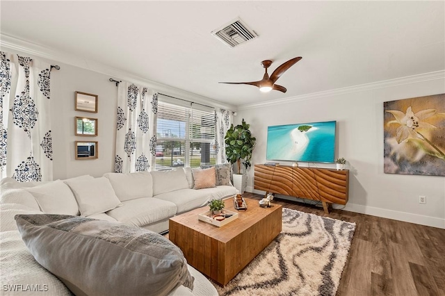 living room with ceiling fan, wood-type flooring, and crown molding