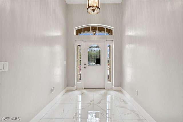 foyer featuring a notable chandelier and a high ceiling