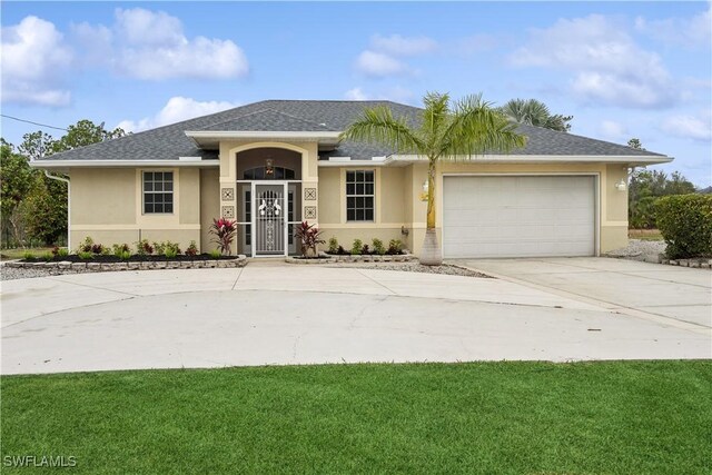 view of front of property with a garage and a front lawn