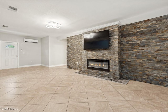 unfurnished living room with light tile patterned flooring and an AC wall unit