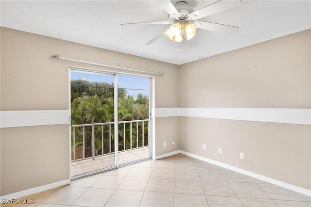 tiled spare room featuring ceiling fan