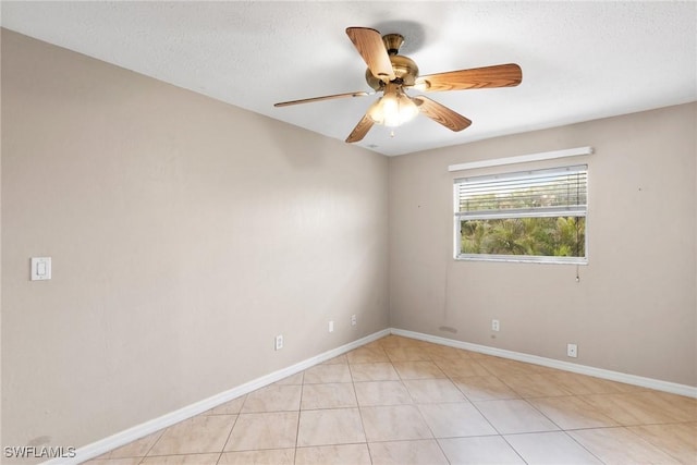 empty room with ceiling fan and a textured ceiling