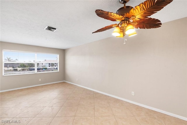 tiled empty room with lofted ceiling, a textured ceiling, and ceiling fan