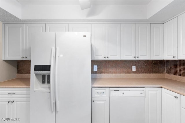 kitchen with white appliances, decorative backsplash, and white cabinets