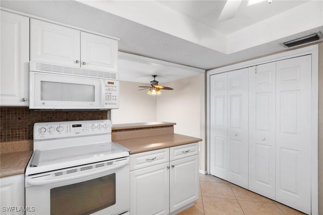 kitchen featuring white cabinetry, light tile patterned floors, white appliances, and ceiling fan