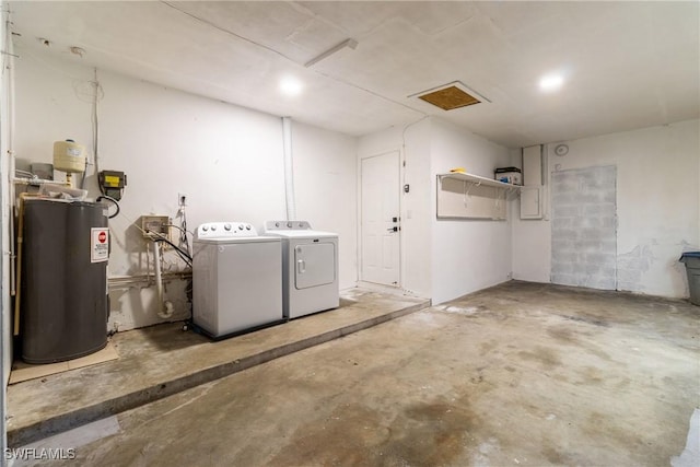 clothes washing area with water heater and separate washer and dryer