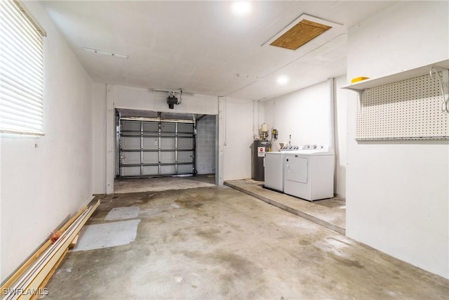 garage featuring washer and clothes dryer, water heater, and a garage door opener