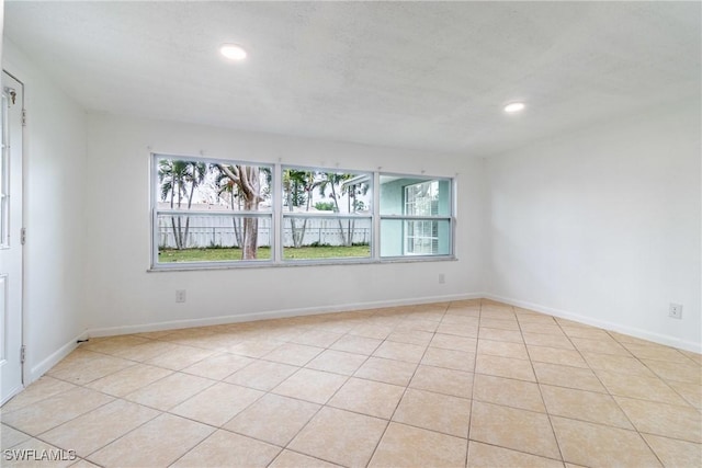 tiled spare room with a wealth of natural light