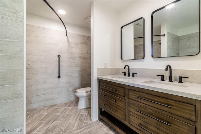 bathroom featuring toilet and vanity