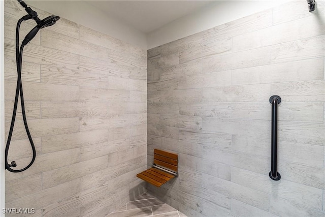 bathroom with tiled shower