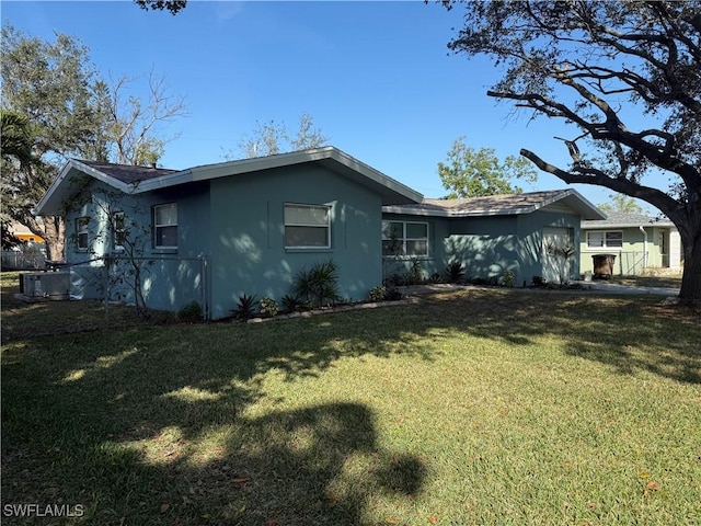 view of property exterior with a yard and central AC unit