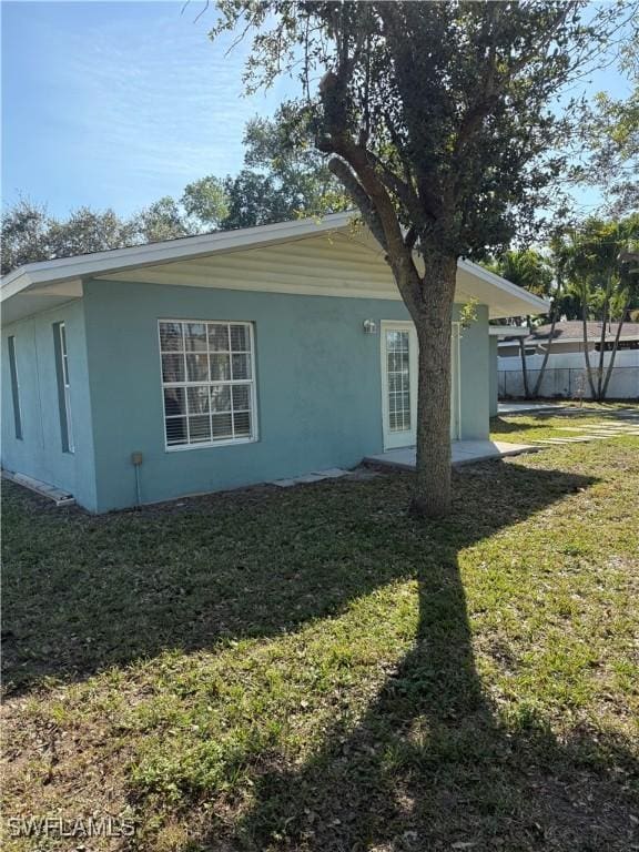 view of property exterior featuring a yard