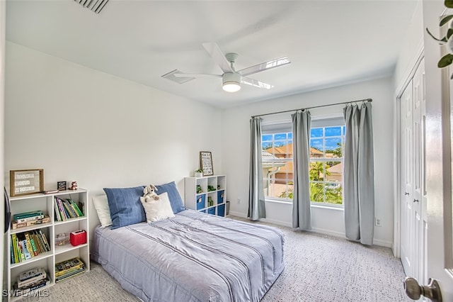 carpeted bedroom featuring a closet and ceiling fan