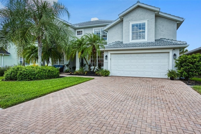 view of front of home featuring a garage and a front lawn