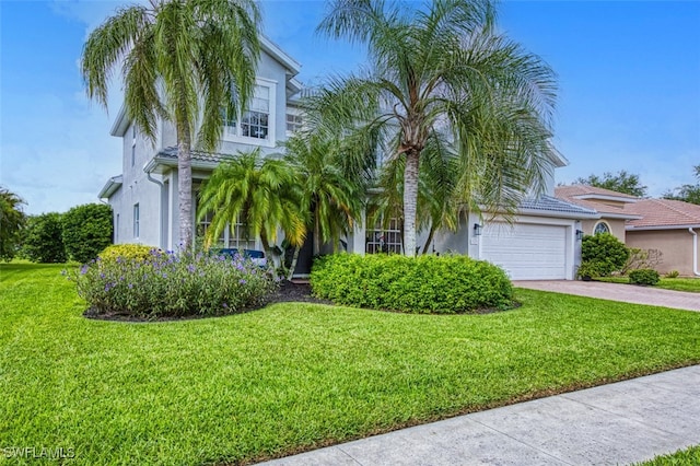 view of front facade featuring a garage and a front lawn