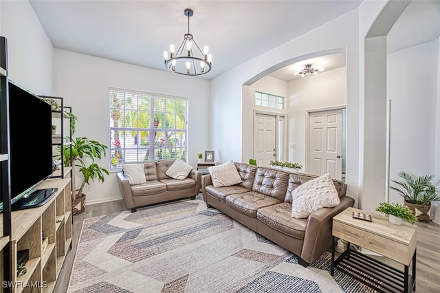 living room featuring a chandelier and light wood-type flooring