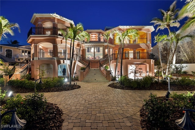 mediterranean / spanish home with stairs and stucco siding