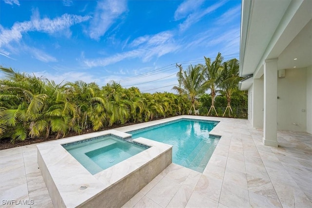 view of pool with an in ground hot tub and a patio